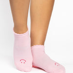 Women wearing brown beige grip socks with white smiley face for Pilates, Barre, Yoga, and beyond. 