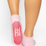 Women wearing brown beige grip socks with white smiley face for Pilates, Barre, Yoga, and beyond. 