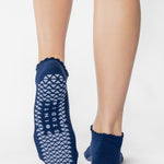 Women wearing navy grip socks with white face for Pilates, Barre, Yoga, and beyond. 