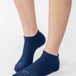 Women wearing navy grip socks with white face for Pilates, Barre, Yoga, and beyond. 