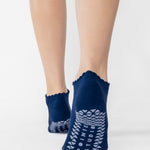 Women wearing navy grip socks with white face for Pilates, Barre, Yoga, and beyond. 