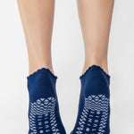 Women wearing navy grip socks with white face for Pilates, Barre, Yoga, and beyond. 