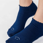 Women wearing navy grip socks with white face for Pilates, Barre, Yoga, and beyond. 