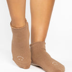 Women wearing brown beige grip socks with white smiley face for Pilates, Barre, Yoga, and beyond. 