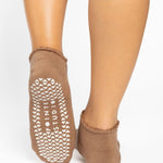 Women wearing brown beige grip socks with white smiley face for Pilates, Barre, Yoga, and beyond. 