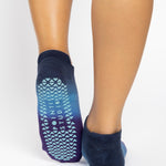 Women wearing a navy blue, light blue, and purple ombre full foot grip sock made for pilates, yoga, barre, and beyond.