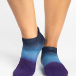 Women wearing a navy blue, light blue, and purple ombre full foot grip sock made for pilates, yoga, barre, and beyond.