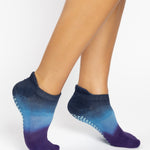 Women wearing a navy blue, light blue, and purple ombre full foot grip sock made for pilates, yoga, barre, and beyond.