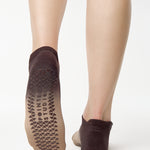 Women wearing a dark brown, light brown, and tan ombre full foot grip sock made for pilates, yoga, barre, and beyond.