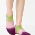 Women wearing a green, pink, and purple ombre full foot grip sock made for pilates, yoga, barre, and beyond.