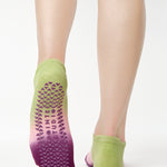 Women wearing a green, pink, and purple ombre full foot grip sock made for pilates, yoga, barre, and beyond.