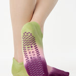 Women wearing a green, pink, and purple ombre full foot grip sock made for pilates, yoga, barre, and beyond.