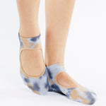 Woman wearing a orange and lavender tie dye grip socks. Made for pilates, barre, yoga, and beyond. 