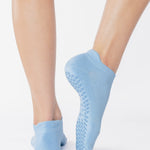 Women wearing a solid light blue full foot grip sock made for Pilates, Barre, Yoga, and beyond. 