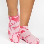 Woman wearing a tan full foot grip sock with it dip dyed with light and hot pink, made for pilates, barre, yoga, and beyond.  
