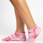 Woman wearing a tan full foot grip sock with it dip dyed with light and hot pink, made for pilates, barre, yoga, and beyond.  