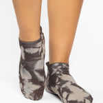 Woman wearing a tan full foot grip sock with it dip dyed with light and dark brown, made for pilates, barre, yoga, and beyond.  