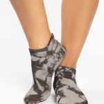 Woman wearing a tan full foot grip sock with it dip dyed with light and dark brown, made for pilates, barre, yoga, and beyond.  
