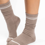 Women wearing a taupe brown crew grip sock with white stripes on the toes and top ankle cuff made for Pilates, Barre, Yoga, and beyond. 