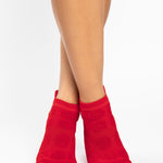 Women wearing red smiley face patterned grip socks made for Pilates, Barre, Yoga, and beyond. 