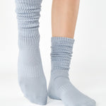 Women wearing a light blue mid-weight knit grip sock that scrunches, made for Pilates, Barre, Yoga, and Beyond. 