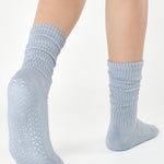 Women wearing a light blue mid-weight knit grip sock that scrunches, made for Pilates, Barre, Yoga, and Beyond. 