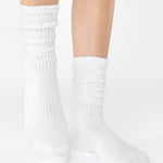 Women wearing a white mid-weight knit grip sock that scrunches, made for Pilates, Barre, Yoga, and Beyond. 