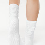 Women wearing a white mid-weight knit grip sock that scrunches, made for Pilates, Barre, Yoga, and Beyond. 