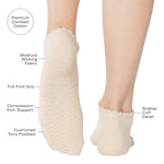 Women wearing a solid off white ivory full foot grip sock with a ruffle cuff and with a red cherry on the top of the toes, made for pilates, barre, yoga, and beyond with all the product features listed.