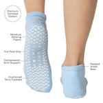 Women wearing a solid white full foot grip sock with a blue evil eye motiff on the top of the toes, made for pilates, barre, yoga, and beyond with a list of product features.