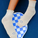 Women wearing off white ankle grip socks with blue happy face for Pilates, Barre, Yoga, and beyond. 