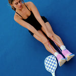 Women wearing off white ankle grip socks with blue happy face for Pilates, Barre, Yoga, and beyond. 