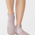 Women wearing light purple grip socks with smiley face for Pilates, Barre, Yoga, and beyond. 