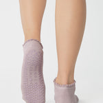 Women wearing light purple grip socks with smiley face for Pilates, Barre, Yoga, and beyond. 
