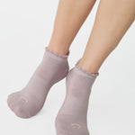 Women wearing light purple grip socks with smiley face for Pilates, Barre, Yoga, and beyond. 