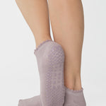 Women wearing light purple grip socks with smiley face for Pilates, Barre, Yoga, and beyond. 