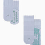A 2 grip sock pack of light blue ankle happy face styles one for a kid ages 4-7 and one matching for an adult. 