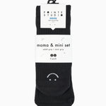 A 2 grip sock pack of black ankle happy face styles one for a kid ages 4-7 and one matching for an adult. 