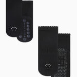 A 2 grip sock pack of black ankle happy face styles one for a kid ages 4-7 and one matching for an adult. 