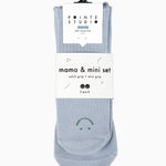 A 2 grip sock pack of light blue ankle happy face styles one for a kid ages 4-7 and one matching for an adult. 