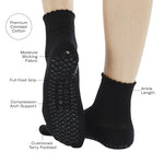Women wearing black ankle grip socks with white happy face for Pilates, Barre, Yoga, and beyond and all features listed