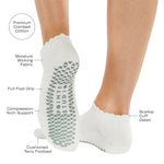 Women wearing white grip socks with green smiley face for Pilates, Barre, Yoga, and beyond with all features listed
