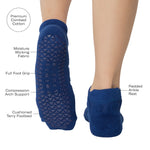 Women wearing blue smiley face patterned grip socks made for Pilates, Barre, Yoga, and beyond with all features listed. 
