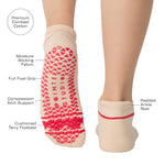 Women wearing a solid off white full foot grip sock with a string of red hearts , made for pilates, barre, yoga, and beyond with a list of products. 