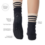 Women wearing a black mid-weight knit grip sock that scrunches with beige stripes on the ankle part, made for Pilates, Barre, Yoga, and Beyond with product features listed.