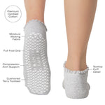 Women wearing a heather grey full foot grip sock with a white heart motif on the top made for Pilates, Barre, Yoga, and beyond with the product features listed.