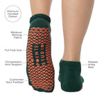 Woman wearing a green full foot grip sock with a yellow namaste message. Made for pilates, barre, yoga, and beyond. With the product features listed. 