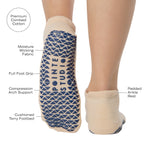 Woman wearing a beige full foot grip sock with a blue namaste message. Made for pilates, barre, yoga, and beyond. With all the product features listed.