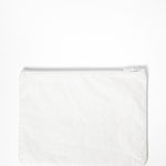 A small white water resistant pouch for pilates, barre, and yoga grip socks. It says "sanity not vanity" on the pouch.