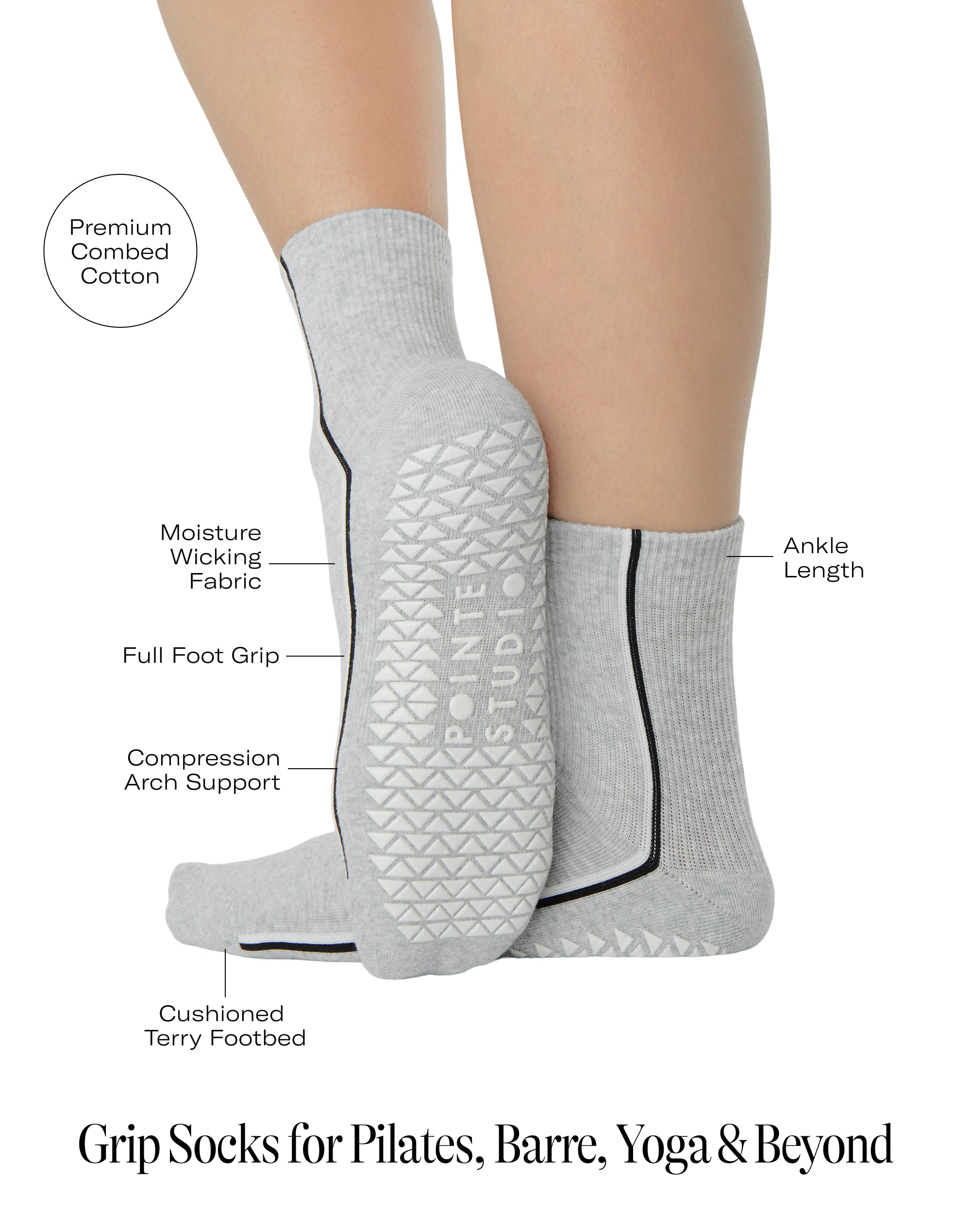 Woman wearing a heather grey solid color ankle grip sock with two black and white bold racing stripes on the side, made for pilates, barre, yoga, and beyond. With all the product features listed. 